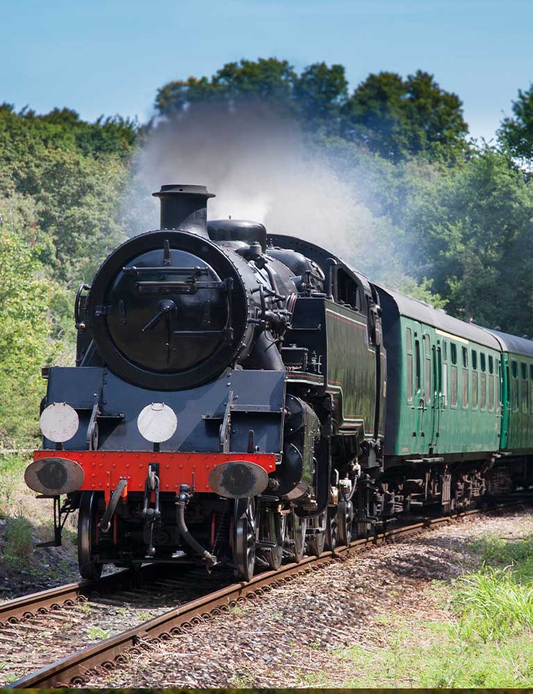 Spa-Valley-railway-web-res-village-pages Black steam train running along the tracks