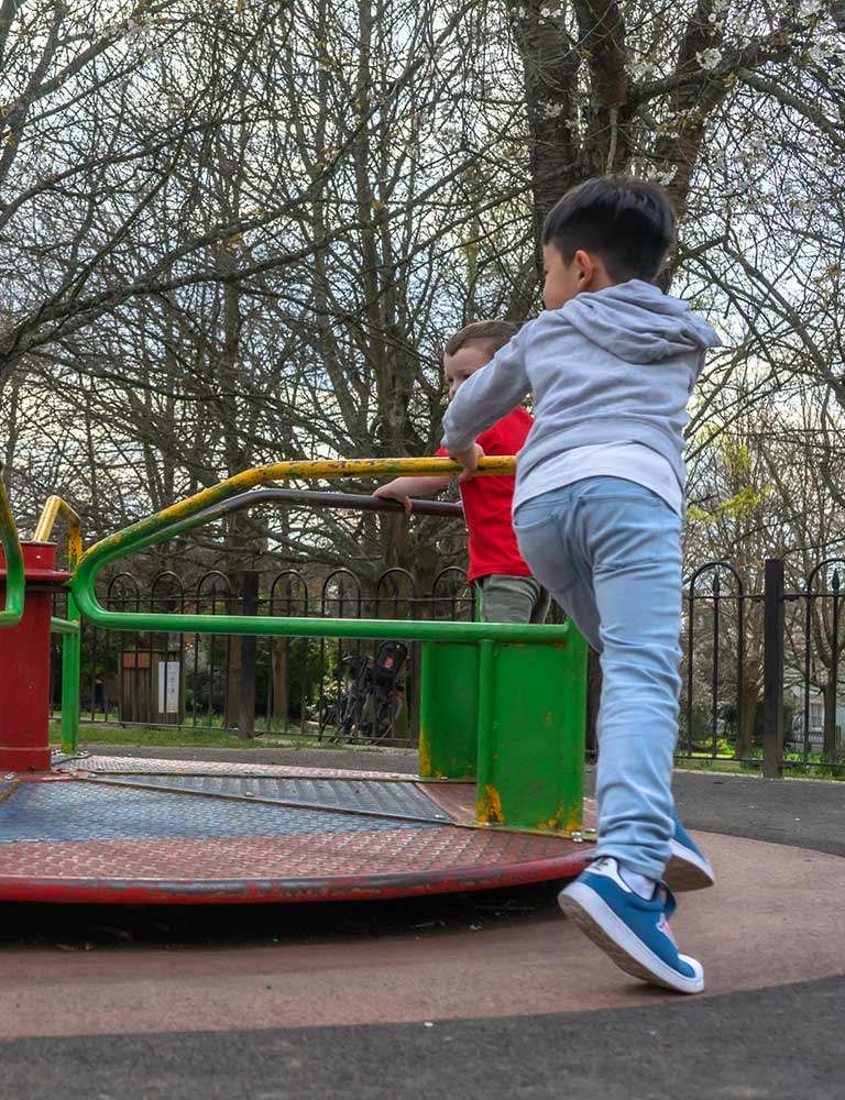 Children playing on a roundabout Children playing on a roundabout
