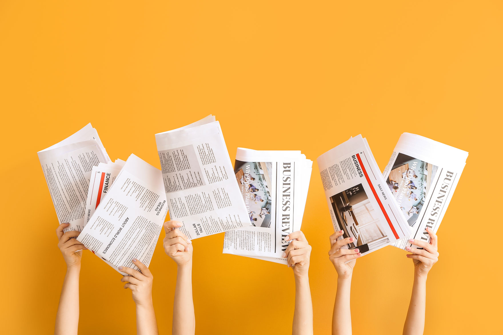 Newspapers being held up by 6 hands Newspapers being held up by 6 hands