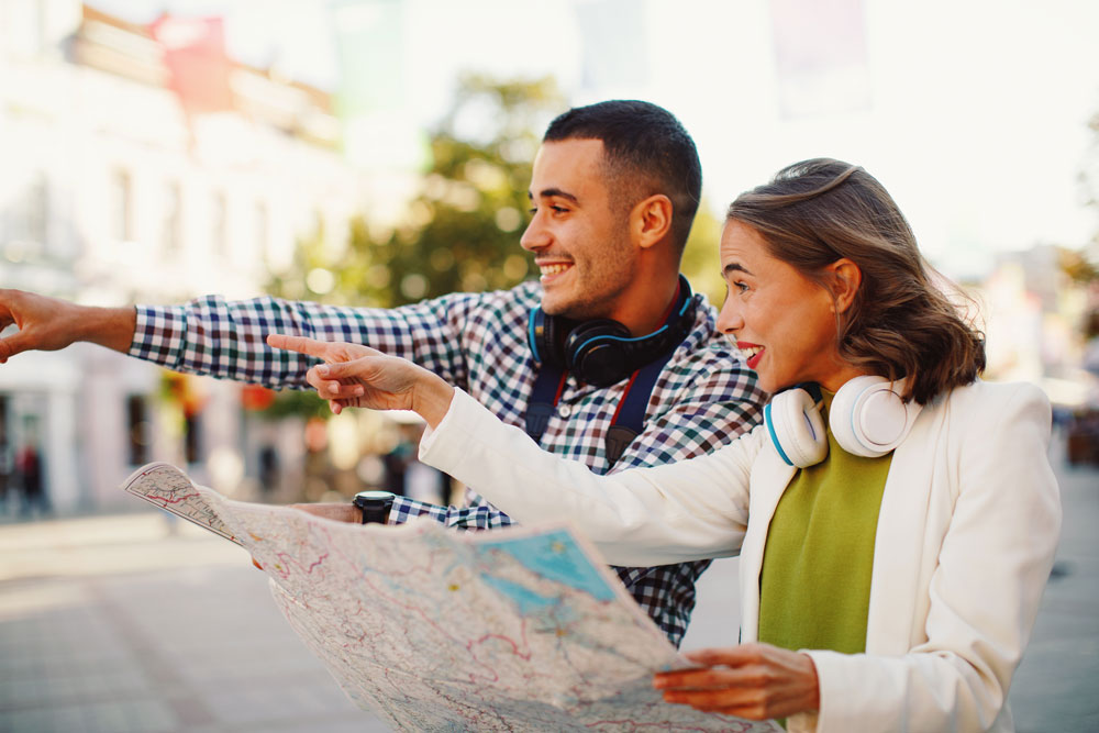 Tourist looking at a map and pointing Tourist looking at a map and pointing