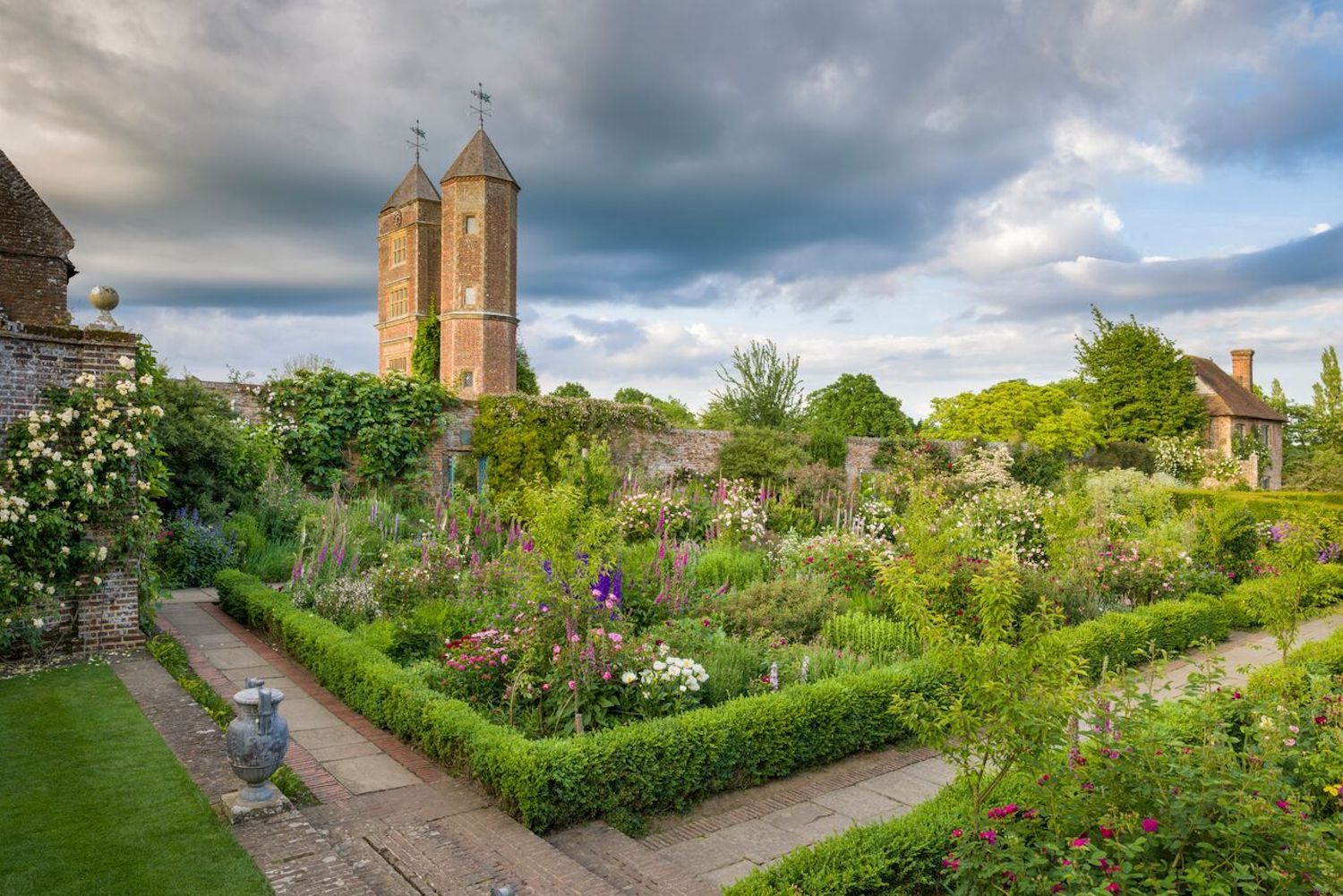 sissinghurst-castle-garden-england A wide angle view of Sissinghurst Castle tower and its gardens filled with beautiful flowers