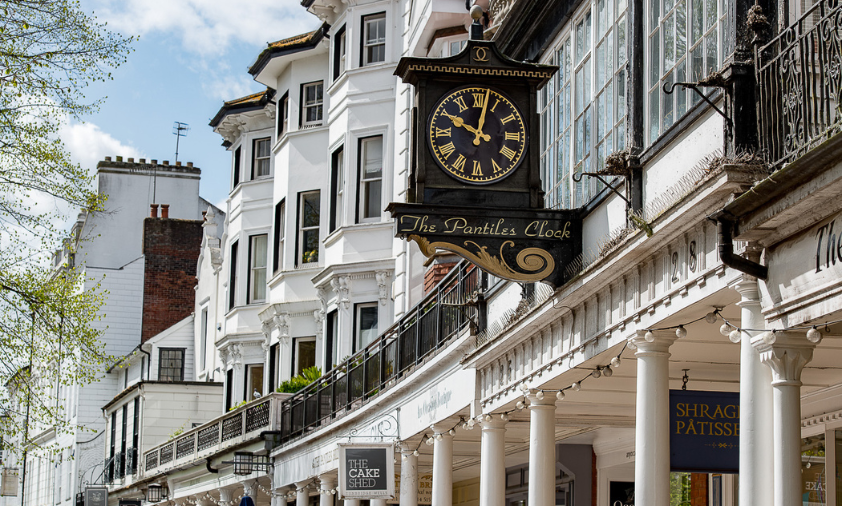 Clock hanging off the side of a building