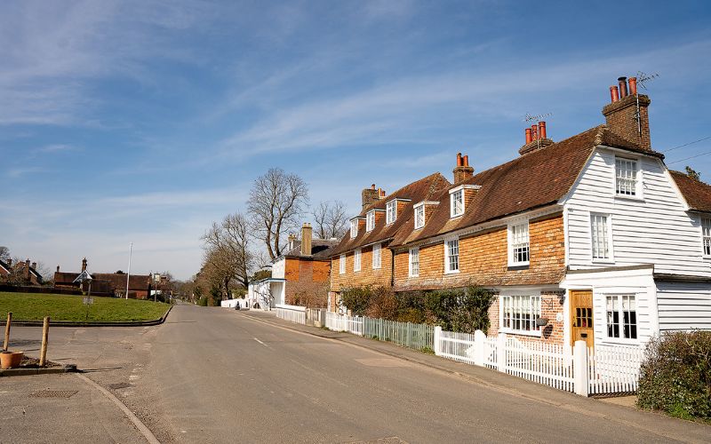 Village street and green to the left